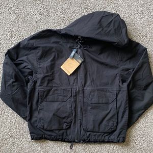 The North Face black windbreaker. New with tag